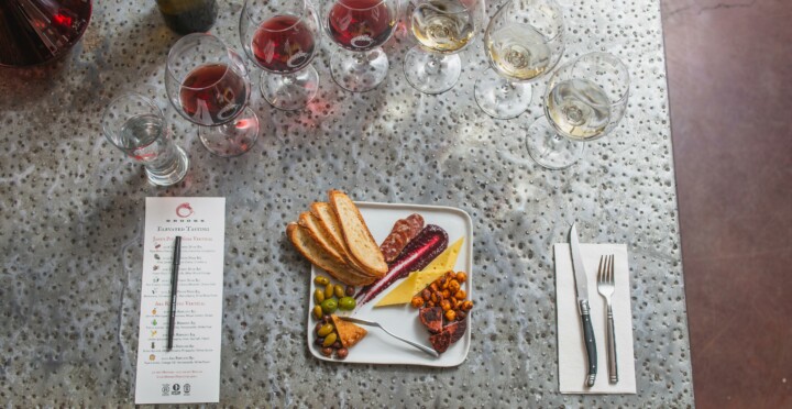 table set with tasting platter and glasses of wine