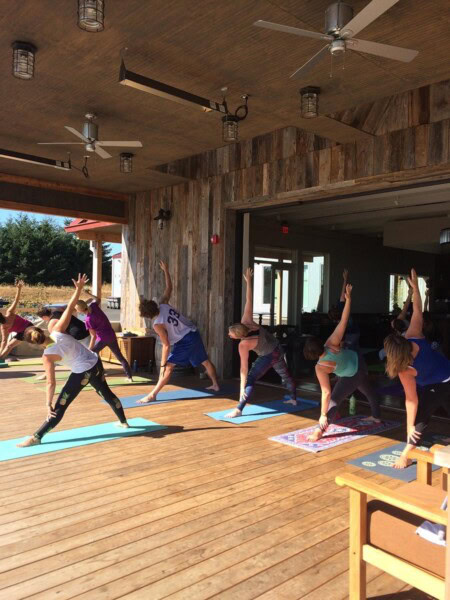 An outdoor yoga class challenges athletes with endurance, flexibility, and focus. 